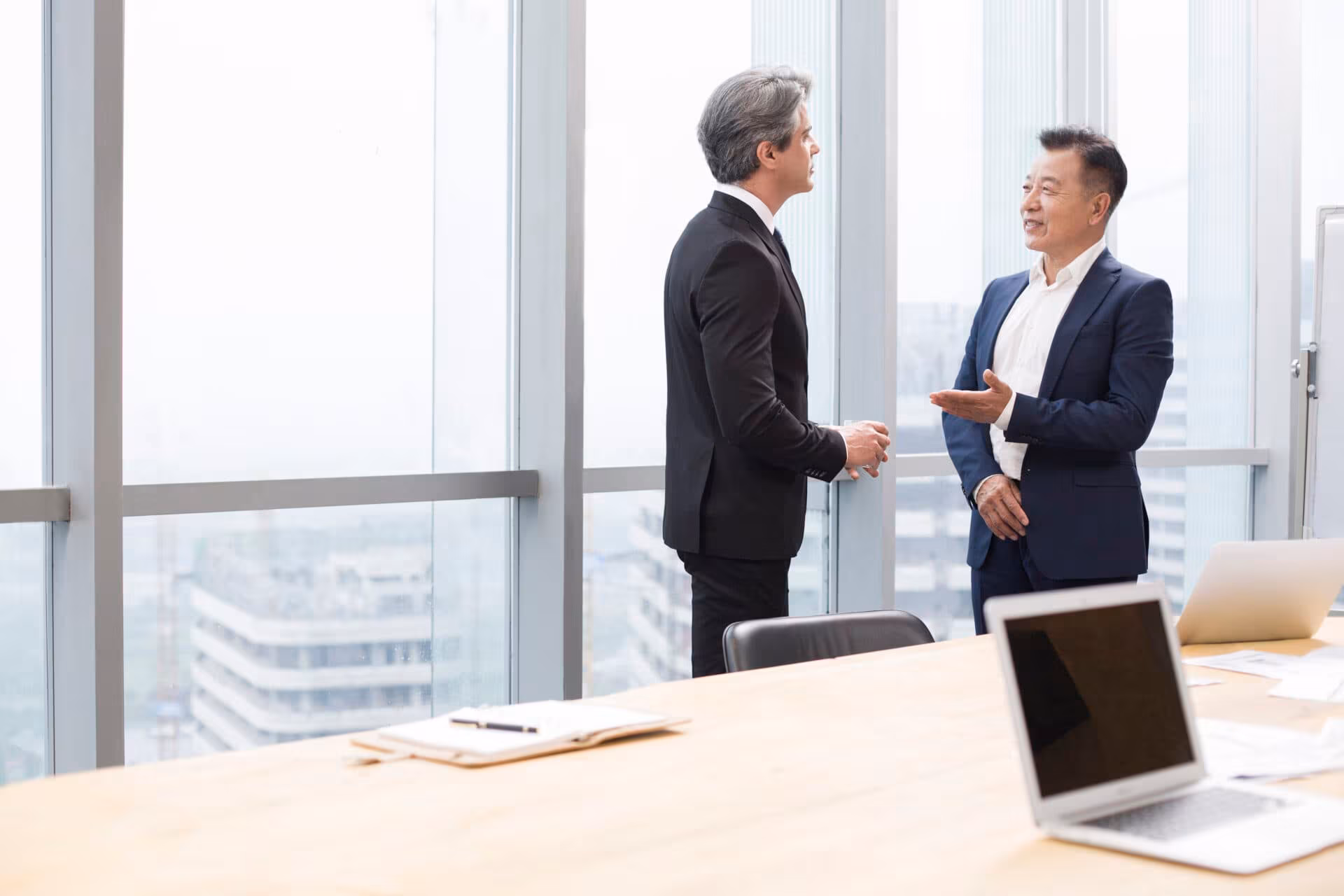 Two professionals in a meeting discussing impact investment